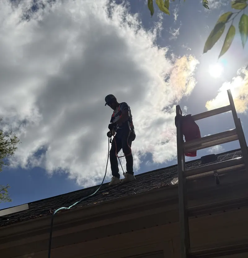 On the roof with the spray hose during a Roof Armor treatment